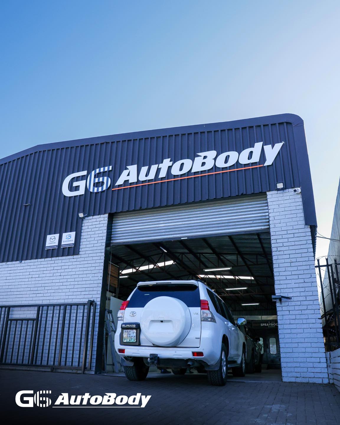 A vehicle backing into the G6 AutoBody workshop bay in Bloemfontein